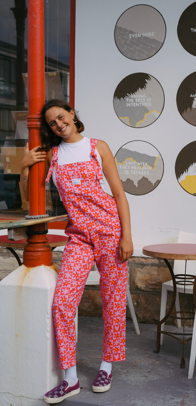 Love is the Honey long dungaree. Pink and Red checkered pattern with flowers. Model wearing size: Medium