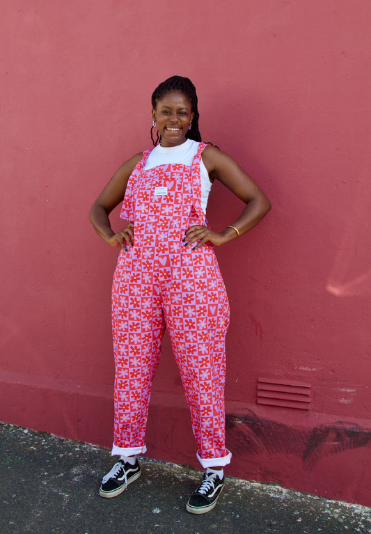 Love is the Honey long dungaree. Pink and Red checkered pattern with flowers. Model wearing size: XL